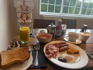 a table with a plate of breakfast food on it at The Coach House in Otterburn