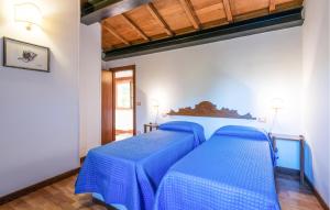 two beds in a room with blue sheets at Lovely Home In Valfornace in Pievebovigliana