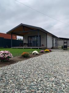 a house with a gravel driveway in front of it at Kashka-Suu house in Verkhnyaya Alaarcha