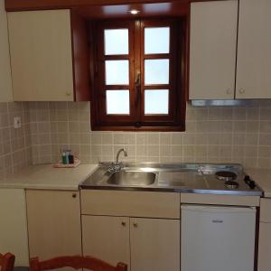 a kitchen with a sink and a window at Alexandros Studios in Kalamaki Chanion