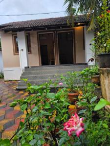 a house with a bunch of flowers in front of it at Joe Banana Stays in Anjuna