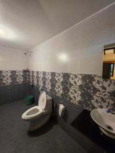 a bathroom with a toilet and a sink at Joe Banana Stays in Anjuna