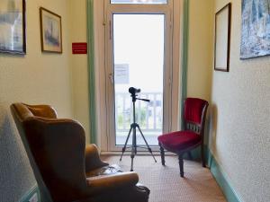 a camera in a room with two chairs and a window at Ron's House in Broadstairs +14 photos