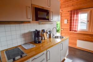 a kitchen with a sink and a counter top at First Camp Haganäset - Charlottenberg in Åmotsfors +9 photos