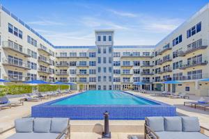 a swimming pool in front of a large building at Proper Design Beautiful View Ready To Enjoy in Palm-Eagle Beach
