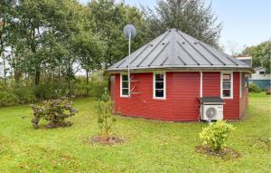 a red house with a gray roof in a yard at Gorgeous Home In Hovborg With Wifi in Hovborg +4 photos