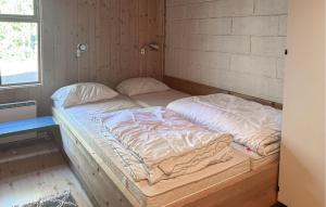 a bed in a room with two pillows on it at Pet Friendly Apartment In Ljørdalen in Ljørdal