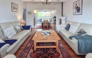 a living room with two couches and a coffee table at 5 Bedroom Lovely Home In Saint-Martin-Des-Champ in Saint-Martin-des-Champs