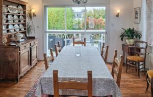 a dining room with a long table and chairs at 5 Bedroom Lovely Home In Saint-Martin-Des-Champ in Saint-Martin-des-Champs