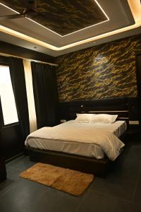 a bedroom with a bed with a stone wall at Shree shyam hotel & restaurant in Mahendragarh
