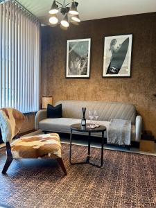 a living room with a couch and a table at Business Park Sofia Cozy Lux & Private Garage Option in Sofia
