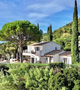 a large white house in the middle of trees at Découvrez la Villa « The View » in Cavalaire-sur-Mer