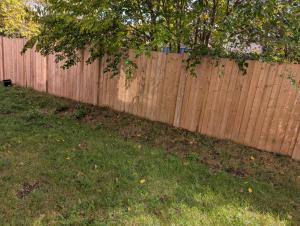 a wooden fence with a grassy yard next to it at Modern 3BR Home Near Niagara Falls & Welland Canal in Welland