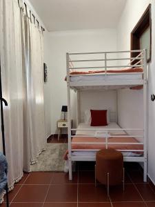 a bedroom with two bunk beds in a room at Casa da Avó Ilda in Miranda do Douro