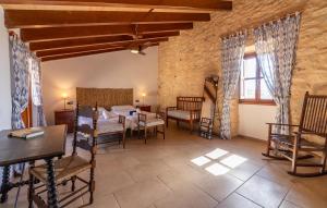 a room with a bed and a table and chairs at Son Pons in Randa