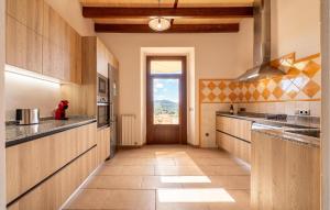 a large kitchen with wooden cabinets and a door at Son Pons in Randa +41 photos