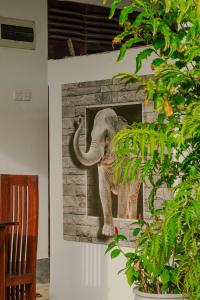 a picture of an elephant hanging on a wall at Surf View Point Ahangama in Ahangama