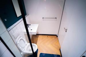 a small bathroom with a toilet and a sink at Modern Studio Steps from Ratanga Park in Cape Town