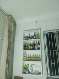 a refrigerator filled with lots of bottles of alcohol at Makucha Ya Simba Homestay and camping grounds in mwanza in Mwanza