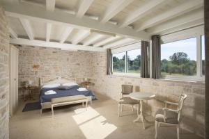 a bedroom with a bed and a table and chairs at Villa Piccolo Paradiso with Heated Pool, Jacuzzi & Sauna in Rovinjsko Selo +49 photos