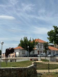 a building with a fence in front of a street at Casa da Avó Ilda in Miranda do Douro
