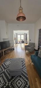 a living room with a couch and a rug at Scotland Holiday Home in Peebles