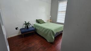 a bedroom with a bed and a potted plant on it at Anashe Home in Pretoria +4 photos