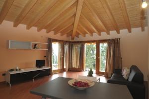 a living room with a table and a couch at La Marina Resort in Pontida
