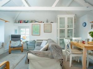 a living room with a couch and a table at The Lookout in Polruan