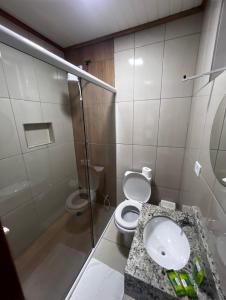 a bathroom with a toilet and a sink and a shower at Pousada Do Siri in Ilha do Mel