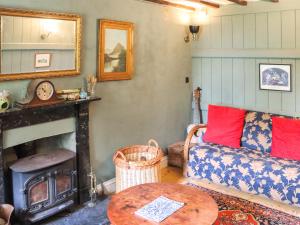 a living room with a couch and a fireplace at Farm House - Uk50262 in Llandeilo