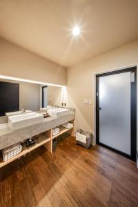 a bathroom with a large sink and a large mirror at Sky deck for rent! Fuji view Open-air bath New building in Fujiyoshida