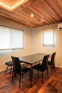 a conference room with a table and chairs at Sky deck for rent! Fuji view Open-air bath New building in Fujiyoshida