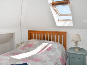 a bedroom with a bed and a window at Riversong in Rhyl