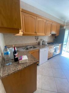 a kitchen with wooden cabinets and a counter top at Monte Fino Bech in Monte Gordo