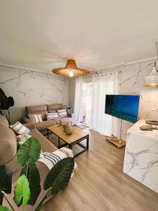 ein Wohnzimmer mit Sofas und einem Flachbildfernseher in der Unterkunft ThE WHALE HOUSE in El Campello