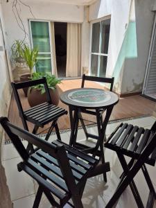 two chairs and a table on a balcony at Casa Boituva in Boituva