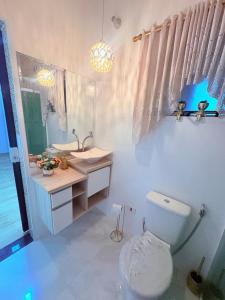 a bathroom with a toilet and a sink at Casa Boituva in Boituva +27 photos
