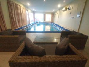 a large swimming pool in a hotel room at شاليه السكون AL Sukun Chalet in Al Ḩadd