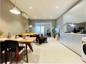 a kitchen and living room with a table and a couch at Quill City Centre Residences Suites KLCC in Kuala Lumpur