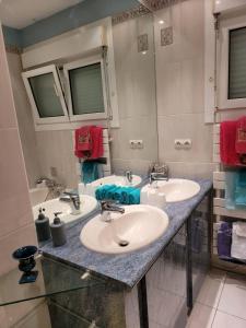 a bathroom with two sinks and a large mirror at Cozy vacation home in Langeais in Langeais +36 photos