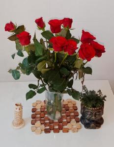 a vase filled with roses sitting on top of a table at Nastaran Nest in Oberhausen +1 photo