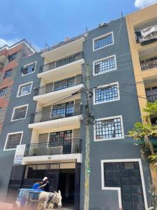 a man and a cow standing in front of a building at Studio Bnb in Kitengela 
