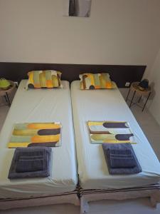 two beds sitting next to each other in a room at The White Houses 7 in Nesebar +31 photos