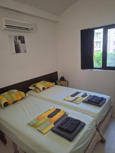 two beds sitting next to each other in a room at The White Houses 7 in Nesebar