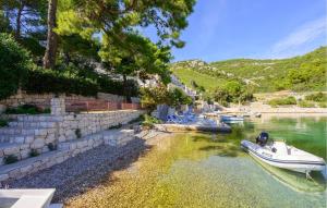 a small boat is docked in a body of water at Beautiful Apartment In Klek With Wifi in Klek +18 photos
