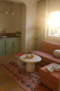 a living room with a couch and a table at Dar Guéliz in Marrakech +46 photos