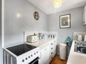 a kitchen with a white stove and a sink at Clarks Yard in Whitby +12 photos