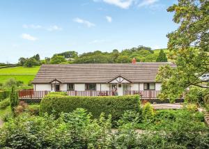 a large white house with a roof at Avalon Cottages in Llangynin