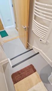 a room with a door and a rug in front of it at Modern 1-Bedroom Flat in SE18 10 mins to O2 in Woolwich